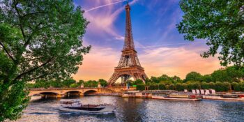 Paris Eiffel Tower and river Seine at sunset in Paris, France. Eiffel Tower is one of the most iconic landmarks of Paris.